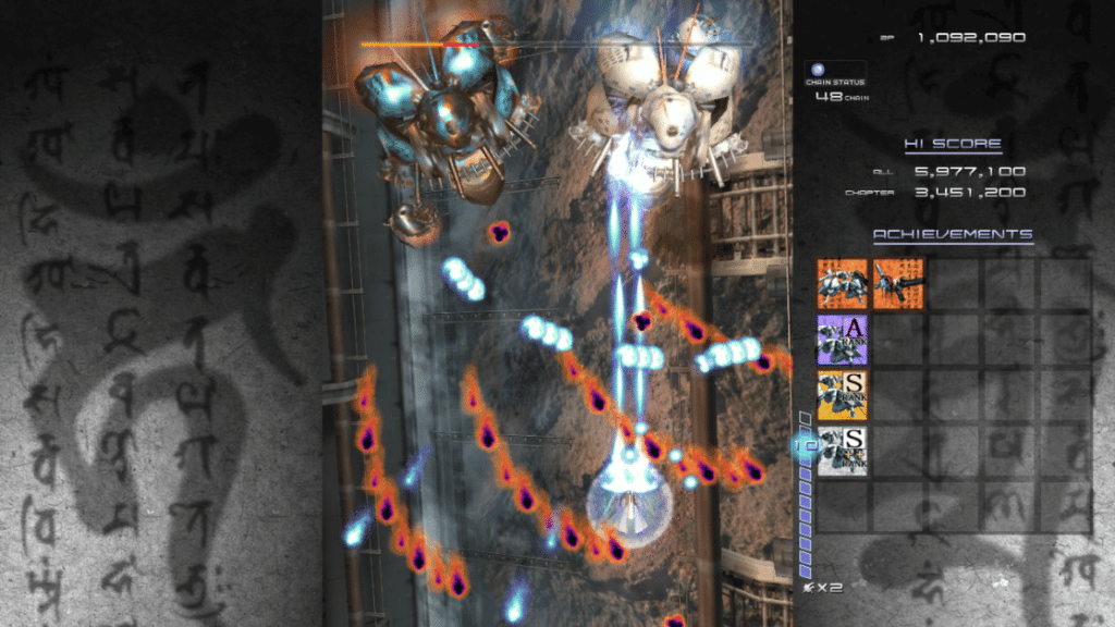 Ikaruga vertical shooter gameplay showing polarity-based bullet hell patterns with blue and orange projectiles, one of the hardest bullet hell games ever made